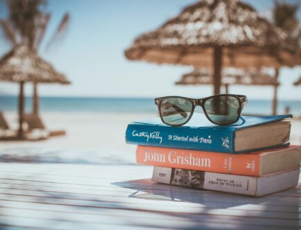 a pair of glasses on the book at the beach